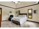 Cozy bedroom with a tray ceiling, a queen-size bed, accent chair, and natural light at 3592 W Smokey Row Rd, Bargersville, IN 46106
