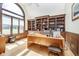 Bright office with built-in bookshelves, large arched window, and hardwood floors at 3592 W Smokey Row Rd, Bargersville, IN 46106