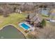 Aerial view of the backyard with the in-ground pool, hot tub, outdoor seating, and pond at 3592 W Smokey Row Rd, Bargersville, IN 46106