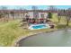 Aerial view showcasing a large in-ground pool, slide, and pond, perfect for outdoor fun and relaxation at 3592 W Smokey Row Rd, Bargersville, IN 46106