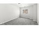 Neutral bedroom featuring plush carpet and a bright window at 5845 Shipwatch Pl, Indianapolis, IN 46237