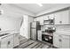 Updated kitchen featuring stainless steel appliances, shaker cabinets, and an eat-in bar at 5845 Shipwatch Pl, Indianapolis, IN 46237