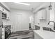 Bright kitchen featuring stainless steel appliances, pantry, and white subway tile backsplash at 5845 Shipwatch Pl, Indianapolis, IN 46237