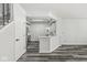 Open-concept living room and kitchen with luxury vinyl plank flooring and crisp, white walls at 5845 Shipwatch Pl, Indianapolis, IN 46237