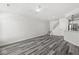 A well-lit living room with grey wood floors, ceiling fan, and neutral walls at 5845 Shipwatch Pl, Indianapolis, IN 46237