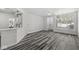 Bright, open-concept living area showcasing wood-look floors and abundant natural light at 5845 Shipwatch Pl, Indianapolis, IN 46237