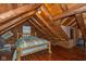 Rustic bedroom with wood walls, a sloped ceiling, and a simple bed frame, offering a cozy escape at 7987 N Lasalle Rd, Morgantown, IN 46160