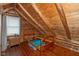 Attic bedroom featuring wood walls, sloped ceilings, and a cozy atmosphere, creating a unique retreat at 7987 N Lasalle Rd, Morgantown, IN 46160