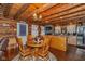 Charming log cabin dining area with wooden table, chairs, and rustic chandelier at 7987 N Lasalle Rd, Morgantown, IN 46160