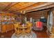 Rustic log cabin dining area featuring hardwood floors and charming chandelier lighting at 7987 N Lasalle Rd, Morgantown, IN 46160