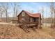 Charming log cabin with a spacious deck, nestled in a wooded setting with lake access at 7987 N Lasalle Rd, Morgantown, IN 46160