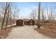Rustic log cabin and shed on a gravel drive surrounded by mature trees, offering privacy and charm at 7987 N Lasalle Rd, Morgantown, IN 46160