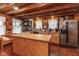 Functional log cabin kitchen with an island, stainless steel appliances, and a warm, inviting atmosphere at 7987 N Lasalle Rd, Morgantown, IN 46160