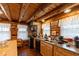 Rustic kitchen featuring log walls, wood cabinets, and modern appliances, creating a cozy culinary space at 7987 N Lasalle Rd, Morgantown, IN 46160