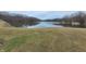A serene view of a peaceful lake, surrounded by lush trees, reflecting a calming and natural setting at 7987 N Lasalle Rd, Morgantown, IN 46160