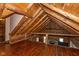 Open loft area with exposed beams, hardwood floors, and a view of the living room below, adding character at 7987 N Lasalle Rd, Morgantown, IN 46160