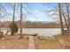Picturesque waterfront view with a wooden dock, small boat, and brick walkway at 7987 N Lasalle Rd, Morgantown, IN 46160