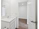Bathroom with single sink and view into bedroom with luxury vinyl plank flooring at 113 Luna Pl, Shelbyville, IN 46176