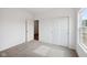 A carpeted bedroom has a large window and entrance doorway at 113 Luna Pl, Shelbyville, IN 46176
