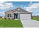 Charming single-story home featuring a brick and vinyl facade, well-manicured lawn, and an attached two-car garage at 113 Luna Pl, Shelbyville, IN 46176