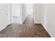 Bright hallway featuring hardwood flooring and white walls, offering a clean and modern aesthetic at 113 Luna Pl, Shelbyville, IN 46176