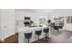 Bright kitchen with stainless appliances, white cabinets, eat-in counter and adjacent dining area at 113 Luna Pl, Shelbyville, IN 46176