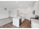 Modern kitchen featuring white cabinets, stainless steel appliances, a center island and hardwood floors at 113 Luna Pl, Shelbyville, IN 46176
