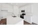 Kitchen with white cabinets, stainless steel appliances, a center island with a sink and wood flooring at 113 Luna Pl, Shelbyville, IN 46176