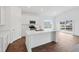 Well-lit kitchen featuring white cabinets, stainless steel appliances, a center island and hardwood floors at 113 Luna Pl, Shelbyville, IN 46176