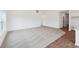 Spacious living room featuring carpet flooring, white walls, and large windows for natural light at 113 Luna Pl, Shelbyville, IN 46176