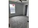 Bedroom with gray carpet, a window, and ceiling fan at 1433 Wigwam Ln, Martinsville, IN 46151