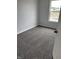 Bright bedroom featuring soft gray carpet and a window at 1433 Wigwam Ln, Martinsville, IN 46151