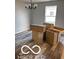 Dining room boasts modern chandelier lighting fixture and new gray hardwood flooring at 1433 Wigwam Ln, Martinsville, IN 46151