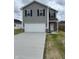 Charming two-story home with a gray exterior, white garage door, and well-maintained lawn at 1433 Wigwam Ln, Martinsville, IN 46151
