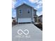 Charming two-story home with gray siding, a wide driveway, and a spacious two-car garage at 1433 Wigwam Ln, Martinsville, IN 46151