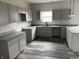 Well-equipped kitchen with granite countertops, gray cabinets, and a stainless steel faucet at 1433 Wigwam Ln, Martinsville, IN 46151