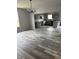Open-concept living space with modern gray flooring and a stylish light fixture at 1433 Wigwam Ln, Martinsville, IN 46151