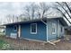 Side view of a ranch home with blue siding and a white picket fence at 1509 Edgewood Dr, Crawfordsville, IN 47933