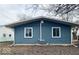 Rear view of ranch home showcasing blue siding and a deck at 1509 Edgewood Dr, Crawfordsville, IN 47933