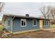 Ranch home with blue siding, new windows and a spacious deck at 1509 Edgewood Dr, Crawfordsville, IN 47933