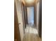 Light-colored hallway flooring and wood-paneled walls at 1509 Edgewood Dr, Crawfordsville, IN 47933