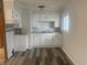 Newly remodeled kitchen with white cabinets and modern flooring at 1509 Edgewood Dr, Crawfordsville, IN 47933