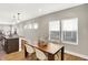Bright dining area with wood table, white chairs, and a view of the kitchen island at 1622 Prospect St, Indianapolis, IN 46203