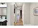 Hallway with modern fixtures, paint and decor leading to stairs and laundry at 1622 Prospect St, Indianapolis, IN 46203