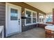Cozy porch featuring brick pillars, a secure mailbox, and windows at 1622 Prospect St, Indianapolis, IN 46203