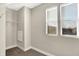 Walk-in closet with two windows and carpet flooring featuring wire shelving on the wall at 1622 Prospect St, Indianapolis, IN 46203
