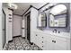 Elegant bathroom with double vanity, patterned floor, and updated fixtures at 2959 Hearthside Dr, Greenwood, IN 46143