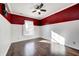 Spacious bedroom with dark hardwood floors and red walls at 2959 Hearthside Dr, Greenwood, IN 46143