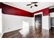 Bright bedroom with dark hardwood floors and red walls at 2959 Hearthside Dr, Greenwood, IN 46143