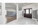 Bright entryway with dark brown door, tile floor, and hardwood floor at 2959 Hearthside Dr, Greenwood, IN 46143